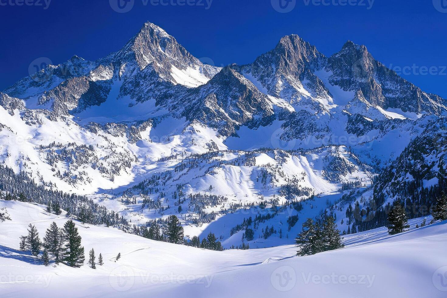 Majestic mountains covered in snow under a clear sky. photo