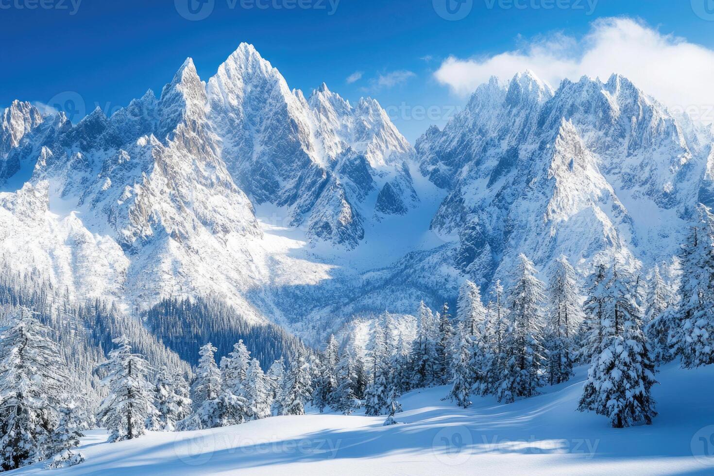 Majestic mountains covered in snow under a clear sky. photo