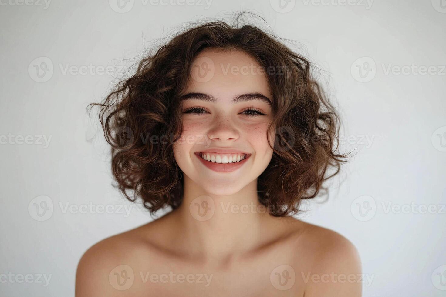 Smiling young woman with sock curls in a white studio. photo