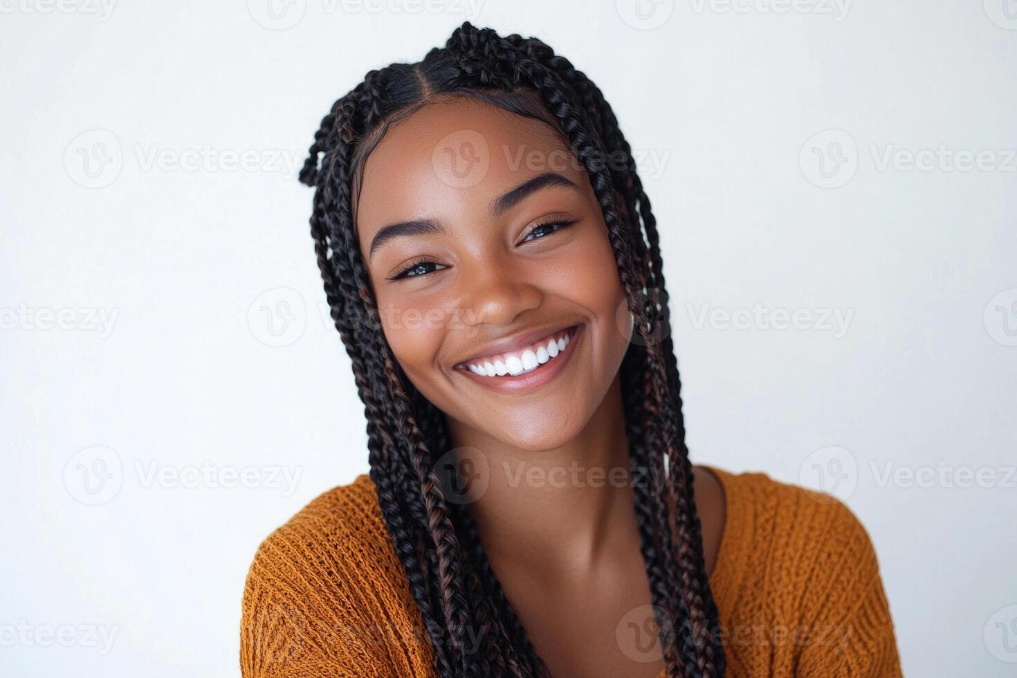 Half-body portrait of a young beautiful woman with boho braids, smiling on a white studio background. photo