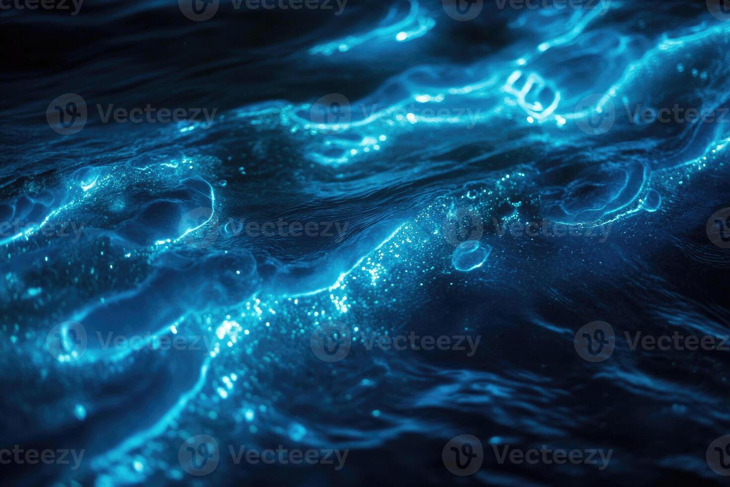 Bioluminescent plankton glow brilliantly in the dark. photo