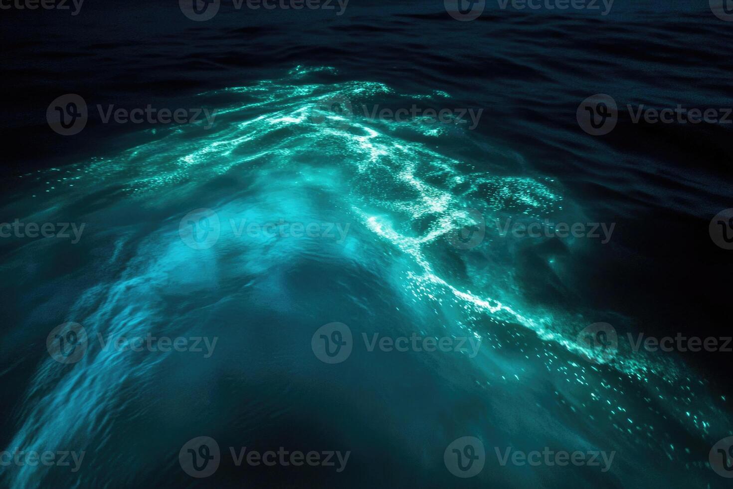 Bioluminescent plankton glow brilliantly in the dark. photo