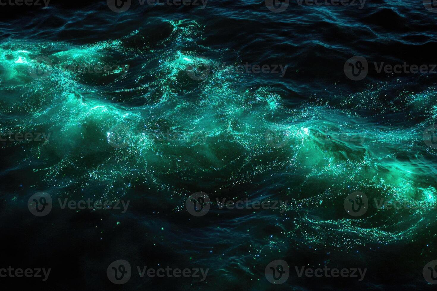 Bioluminescent plankton glow brilliantly in the dark. photo