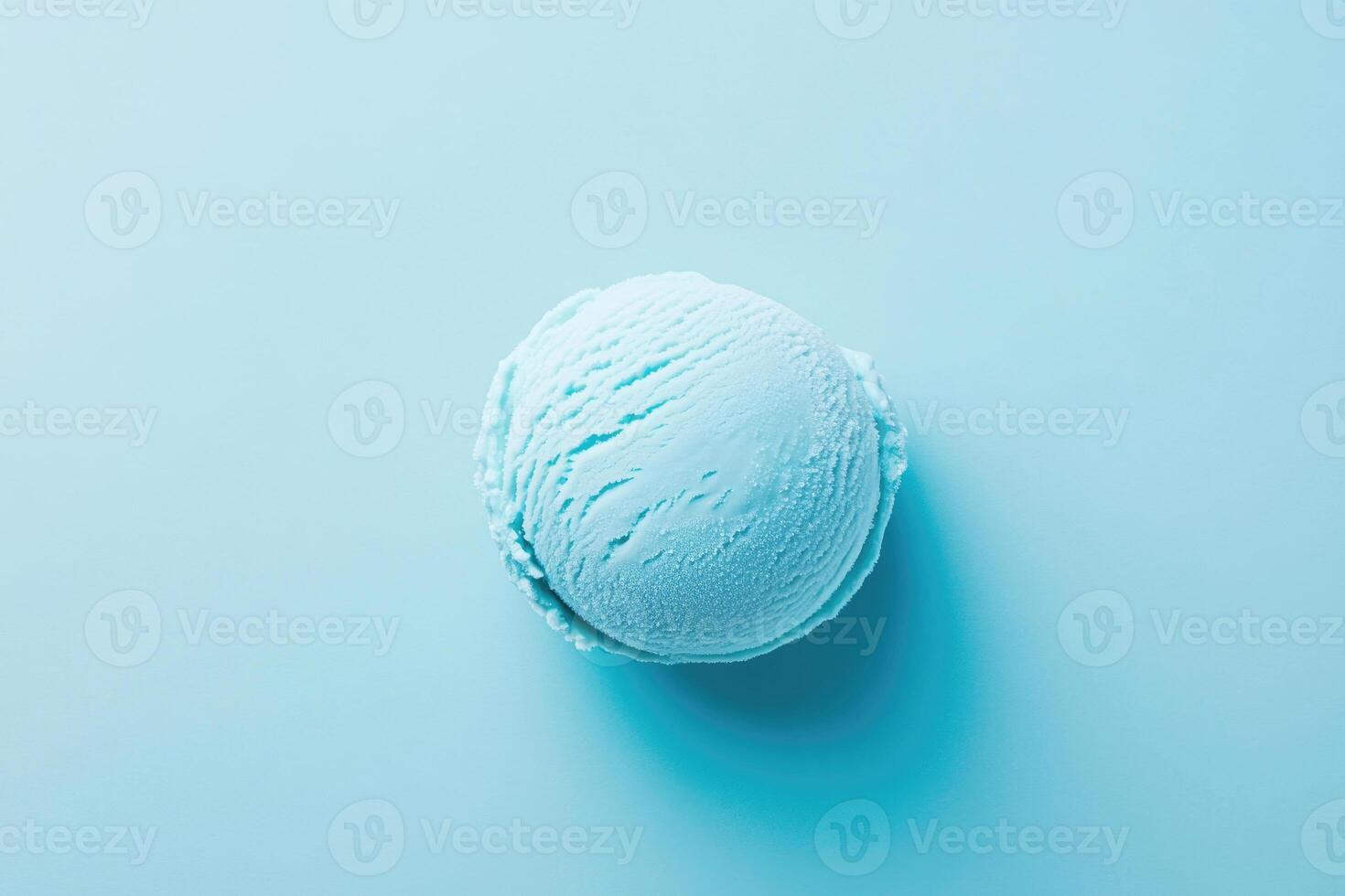 A top-down view of a light blue ice cream scoop on a light blue background. photo