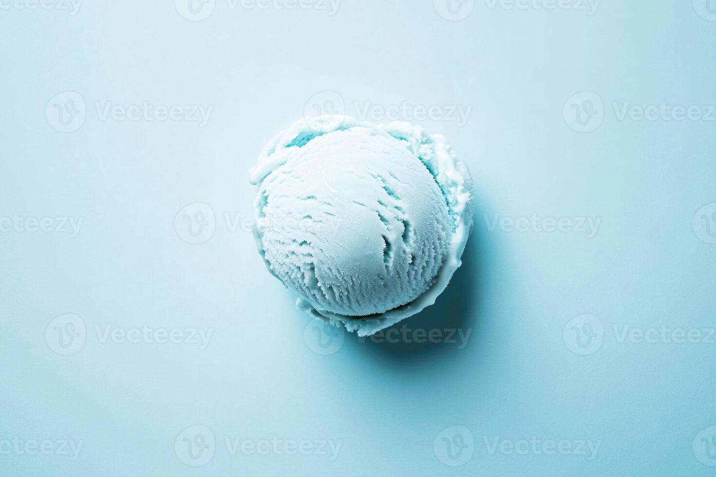 A top-down view of a light blue ice cream scoop on a light blue background. photo