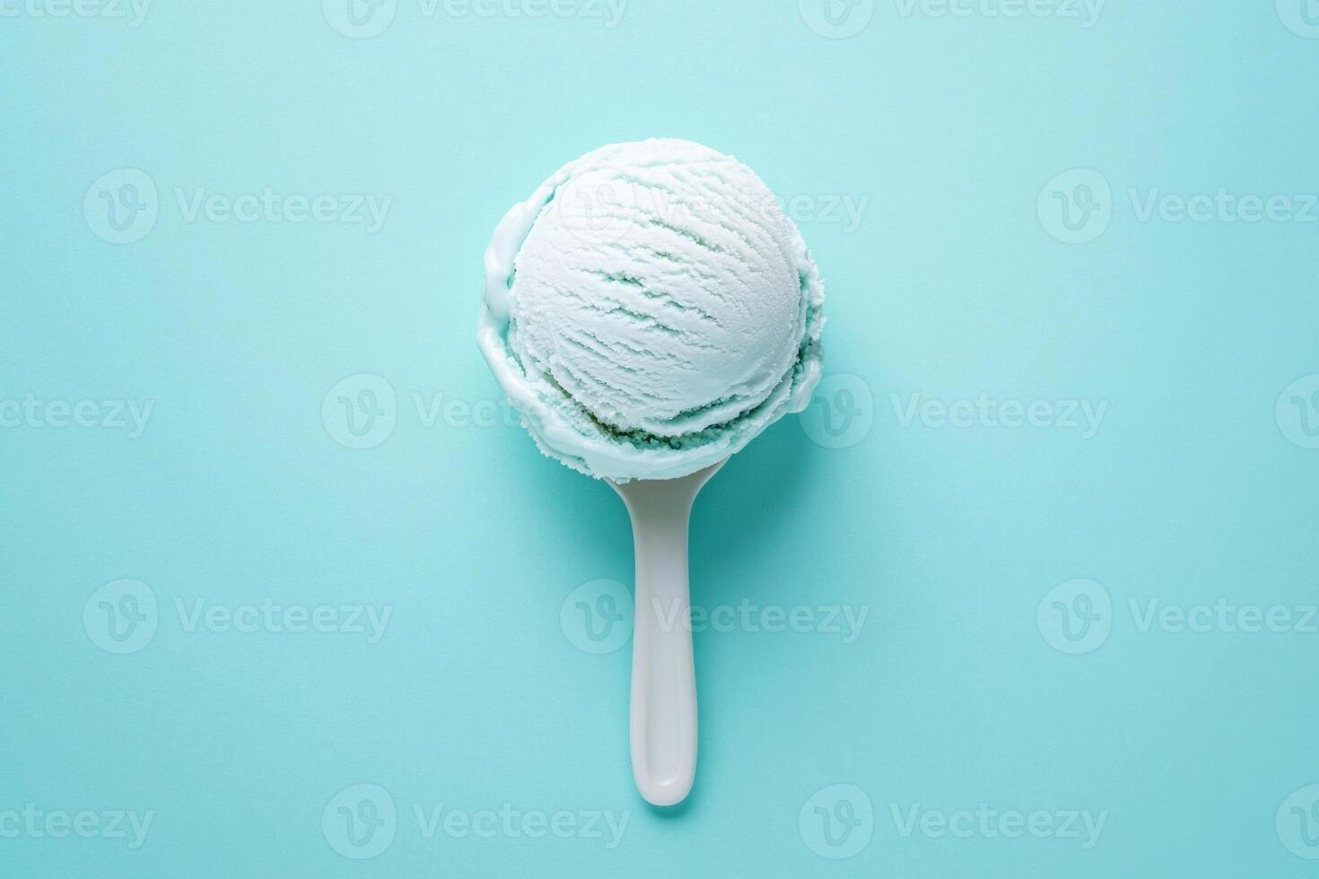 A top-down view of a light blue ice cream scoop on a light blue background. photo