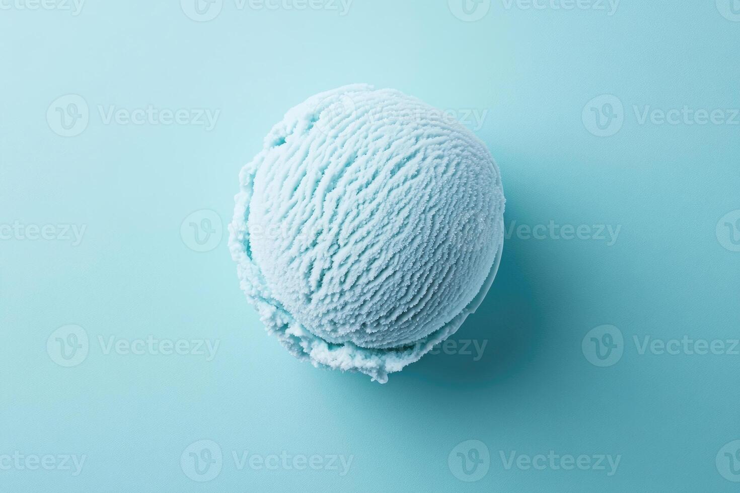 A top-down view of a light blue ice cream scoop on a light blue background. photo