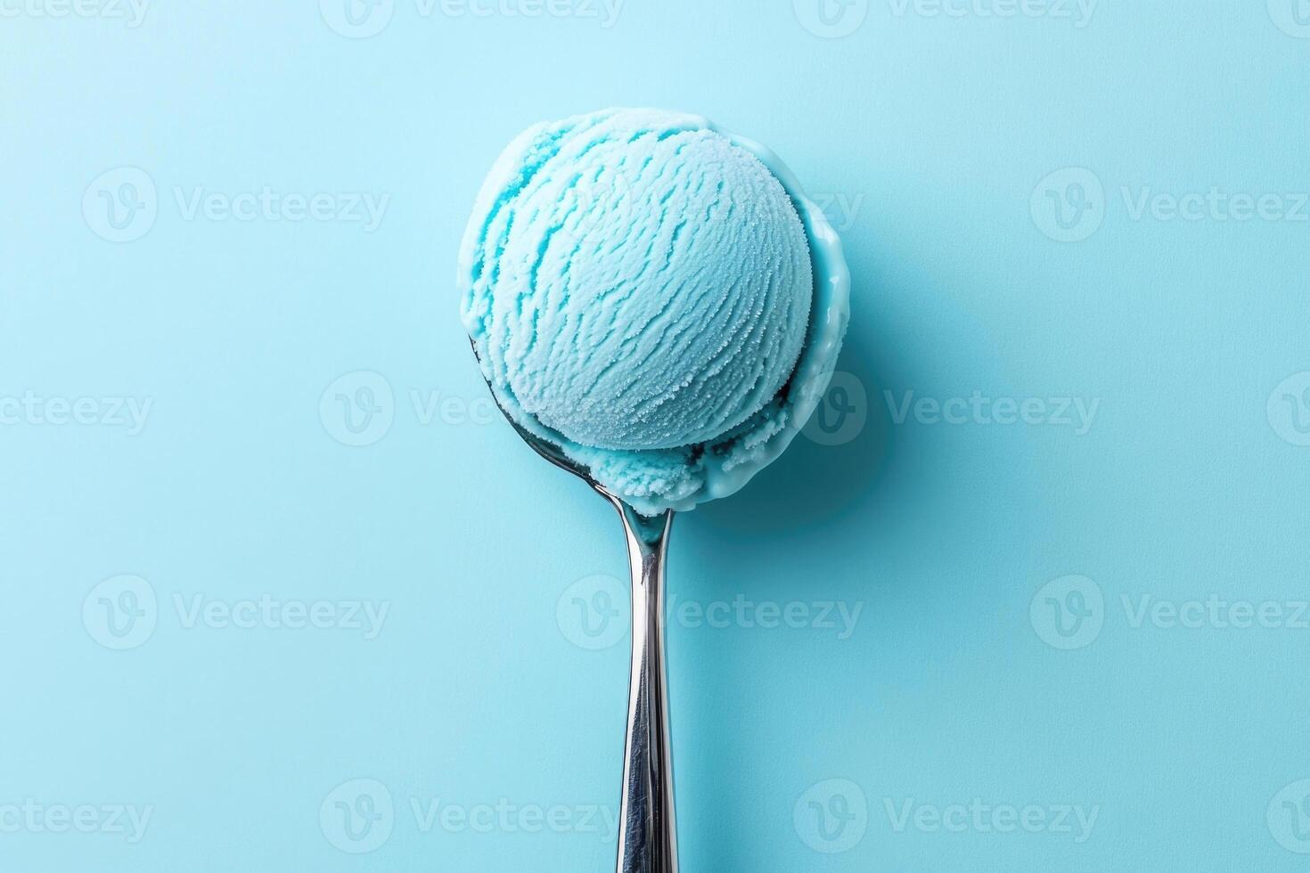 A top-down view of a light blue ice cream scoop on a light blue background. photo