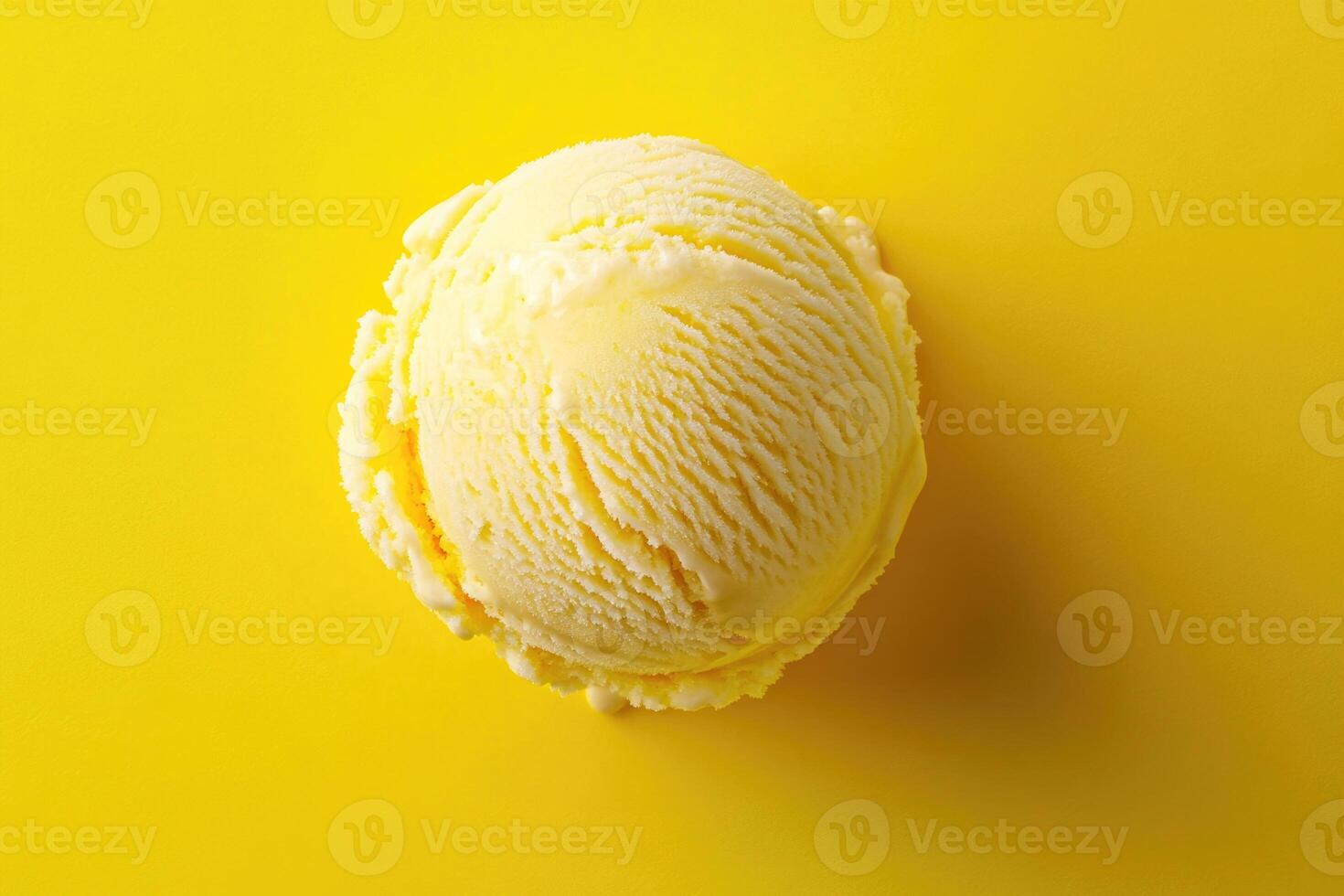 A top-down view of a yellow ice cream scoop on a matching yellow background. photo