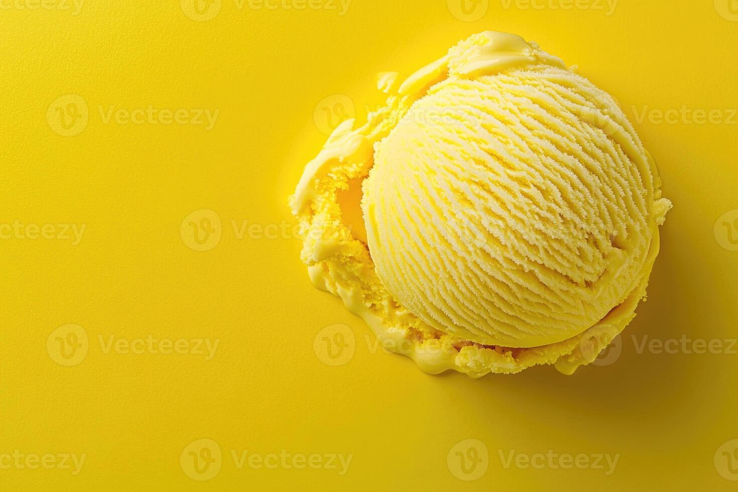 A top-down view of a yellow ice cream scoop on a matching yellow background. photo