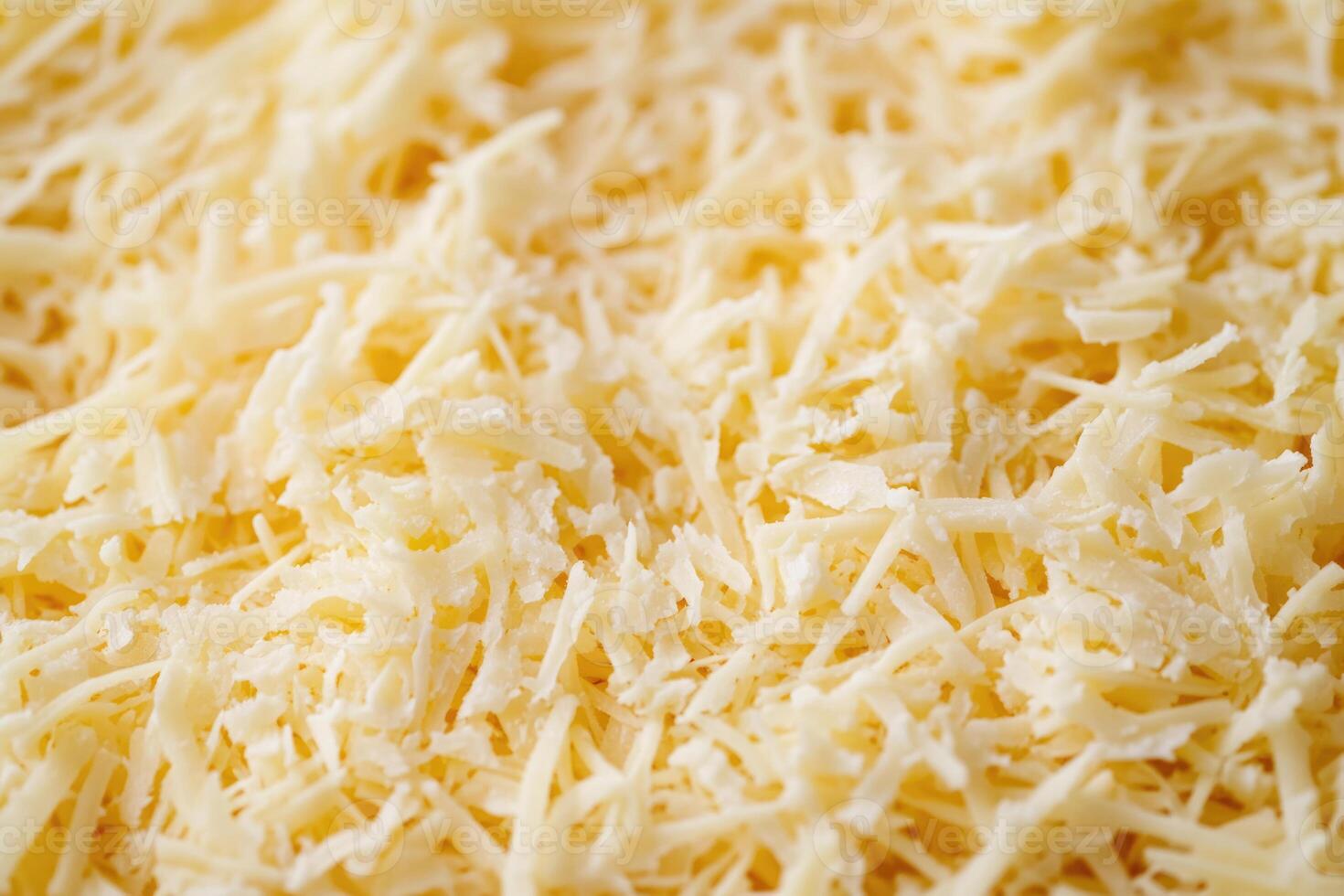 A textured layer of shredded cheese forms a rich, appetizing background. photo