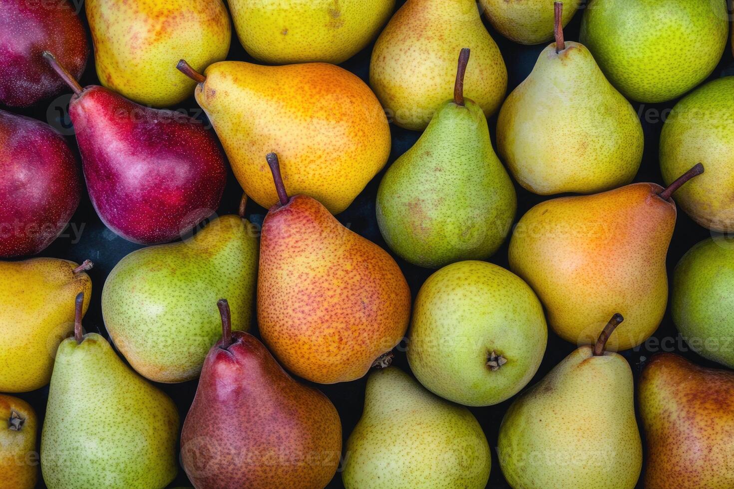 A colorful array of pears forms a rich and textured background. photo