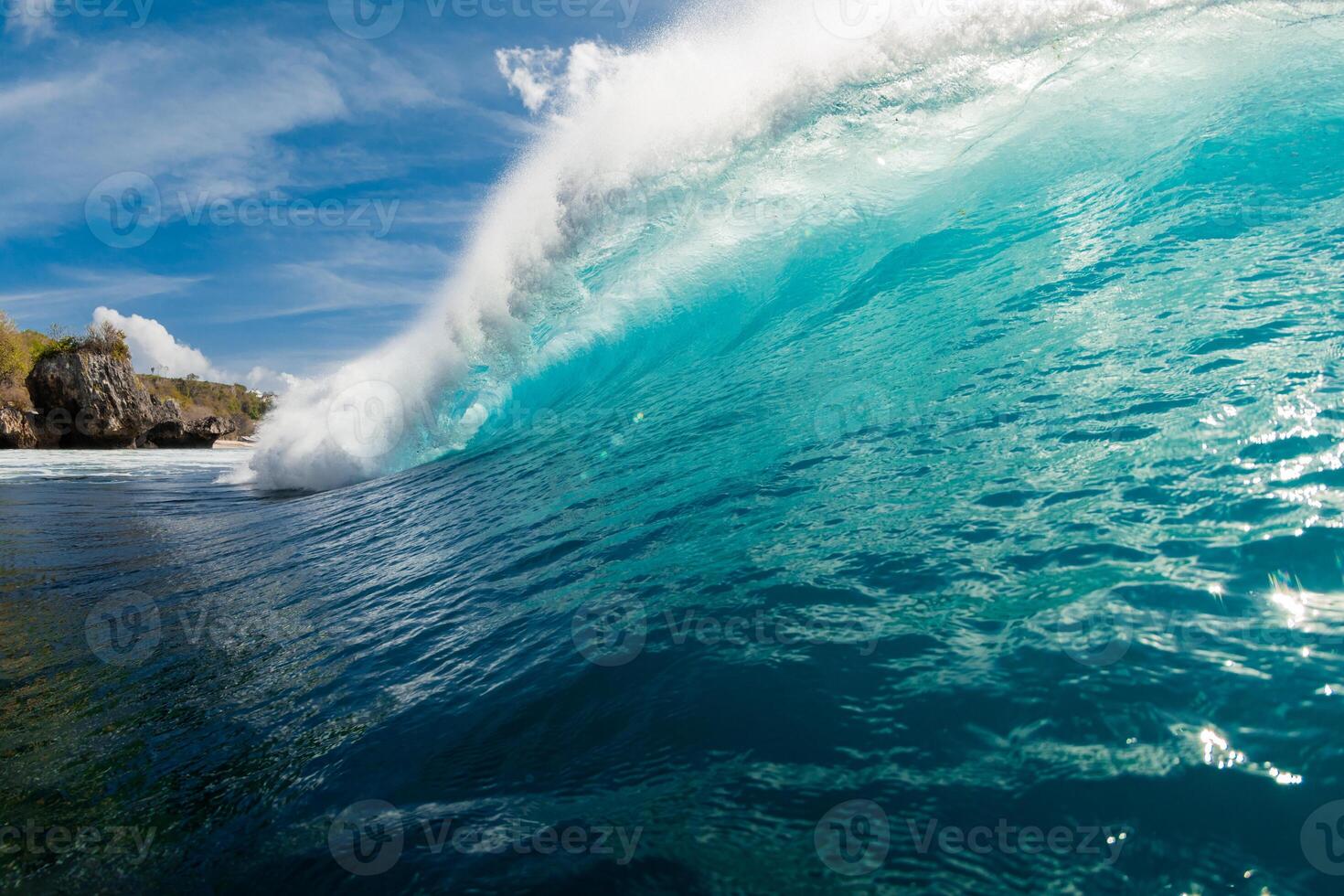 Crashing blue wave in ocean. Wave wall with sun light in Bali photo