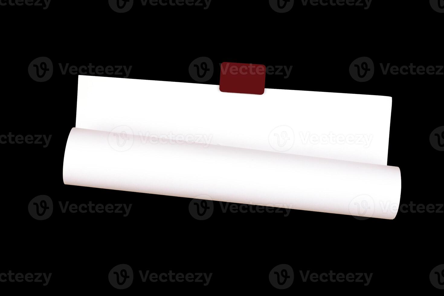 rolled empty sheet of paper on the wall, isolated on black photo