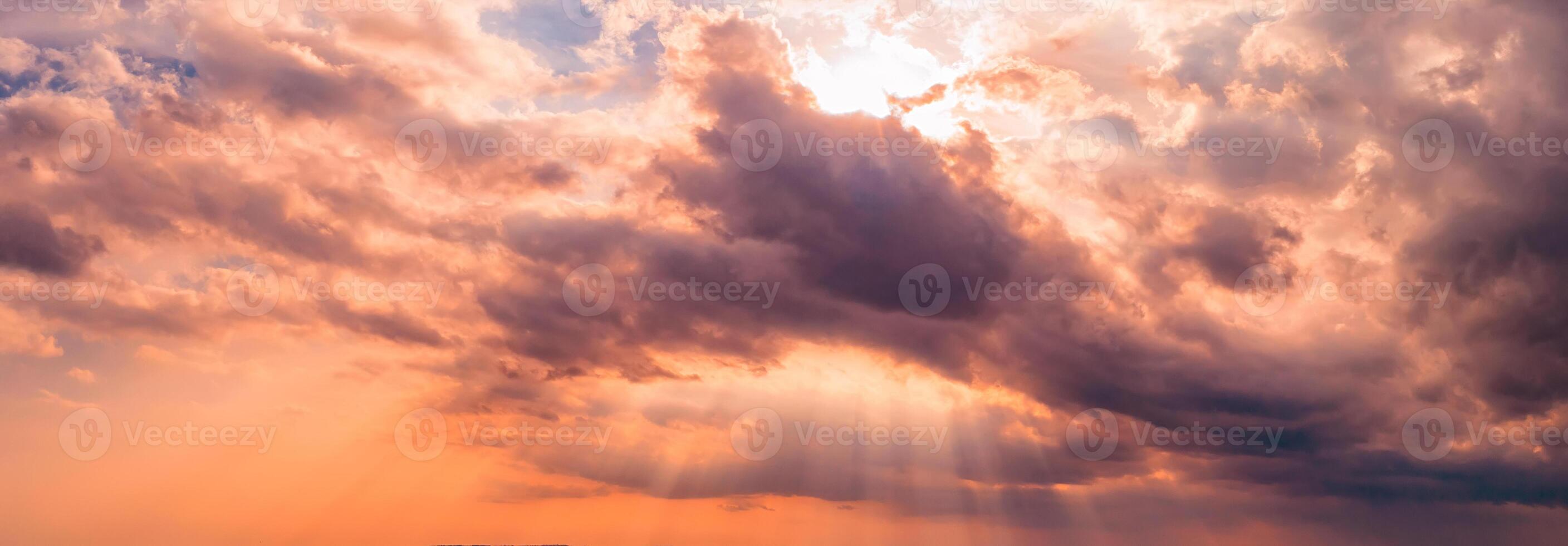 Dramatic clouds and sun rays in the sky photo