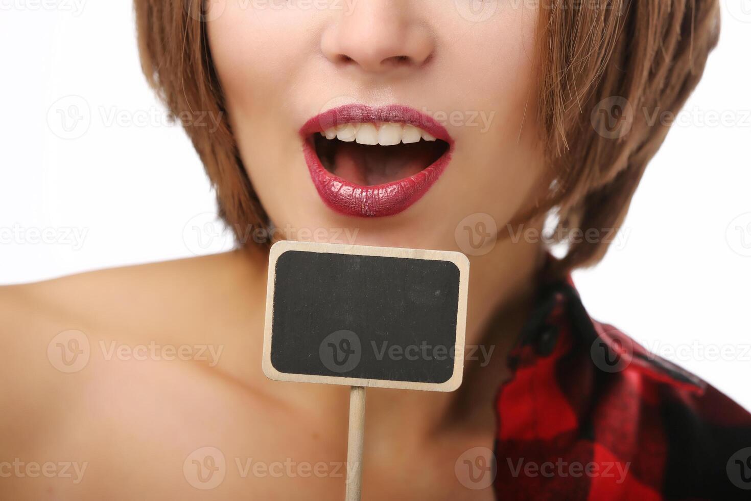 Young beautiful woman with a small tablet for text. Portrait on a white background. photo