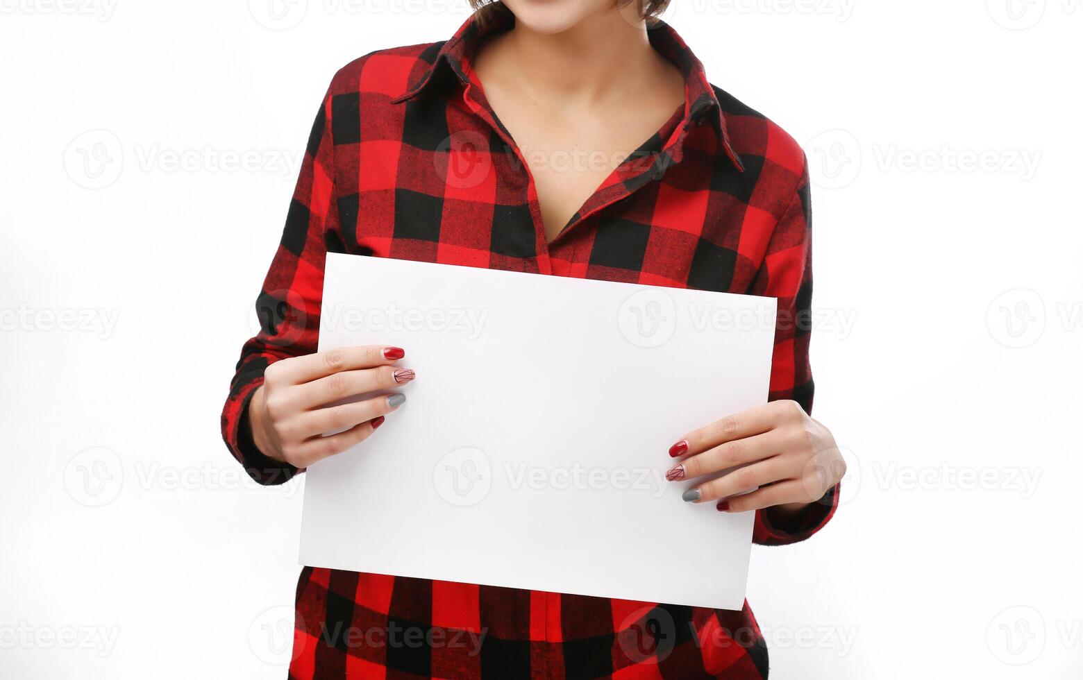 Beautiful woman holds out a blank A4 card. Isolated on white background. Red headed girl. Space for text photo
