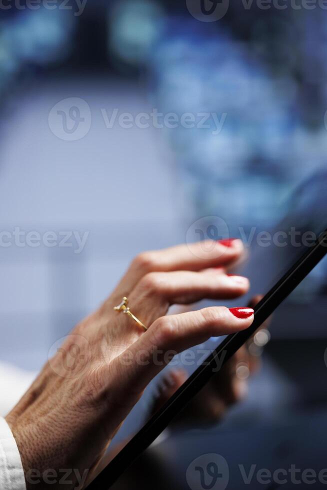 IT programmer using tablet to make sure valuable data remains shielded from security drawbacks, safeguarding high tech workplace servers against unauthorized access and vulnerabilities, close up photo