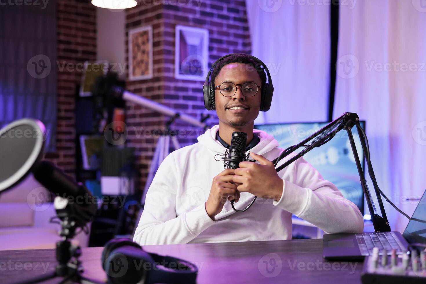 Lifestyle vlogger recording podcast episode with professional camera and sound equipment in studio. Portrait of content creator talking to audience and filming streaming service online show photo