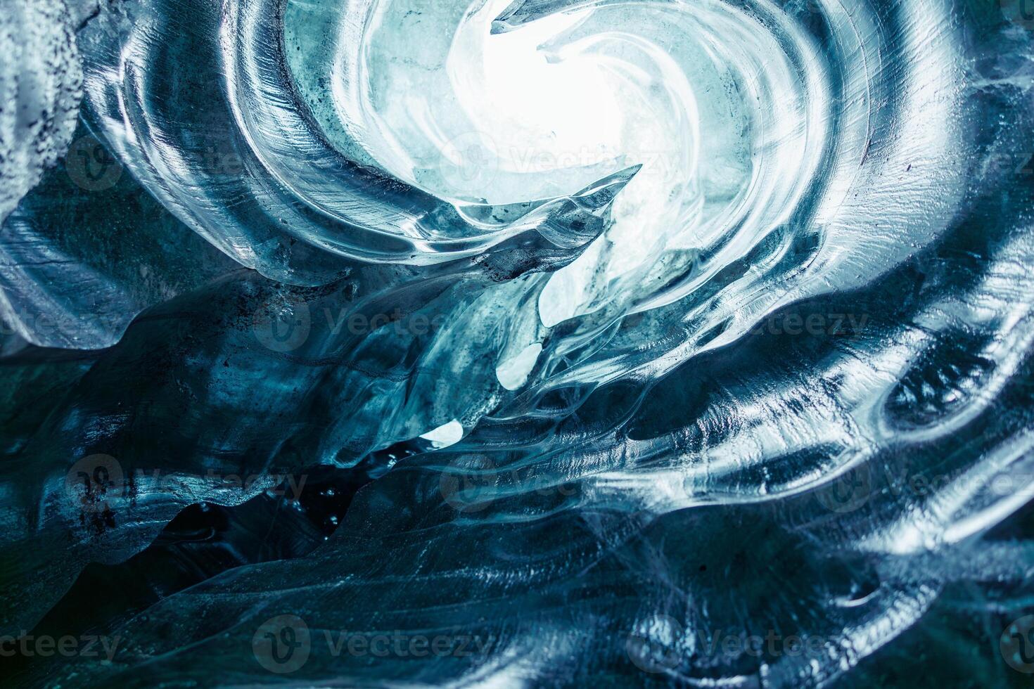 Clear chunks of ice in Vatnajokull glacier crevasse, majestic blue diamond shaped structures inside dazzling frost covered icy caves. Glacial iceberg stones throughout icelandic scenery. photo