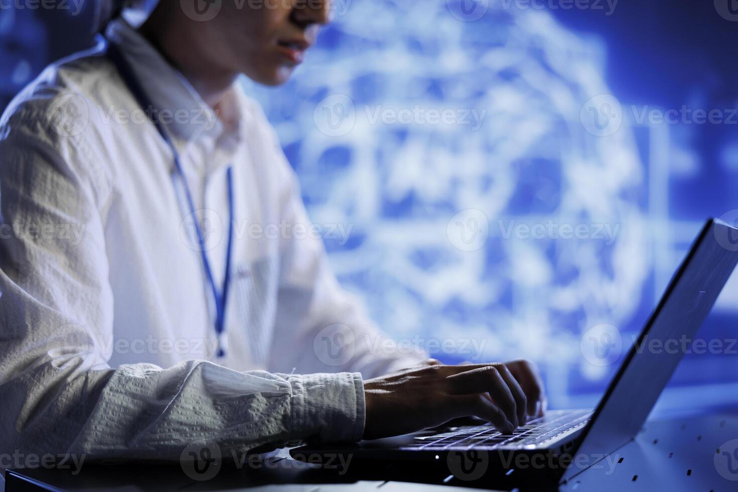 Computer scientist in data center uses artificial intelligence computing simulating human brain through self learning algorithms. System administrator with laptop working with AI deep neural networks photo