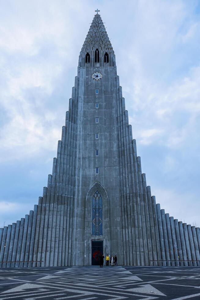 Entrance of hallgrimskirkja church circa March 2023, front door of sacred cathedral of hallgrimur with beautiful stone architecture. Holy lutheran building with religious cross on top. photo