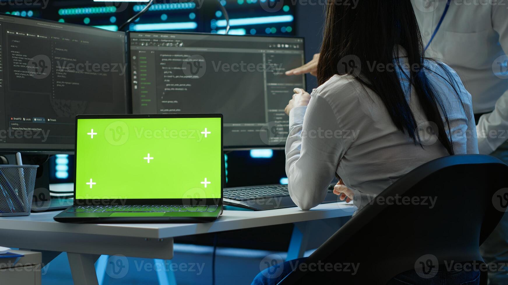 Programmer in data center managing and maintaining databases using chroma key notebook, ensuring data integrity and security. Expert updating server room systems using isolated screen laptop, camera A photo