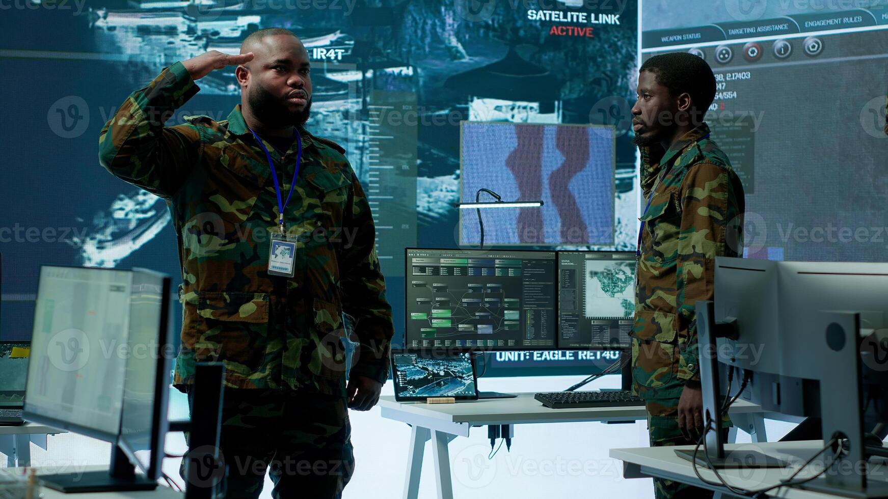 Military personnel operate advanced systems in a command center, focusing on surveillance and data analysis to protect national security. Soldiers trained to manage information warfare. Camera A. photo