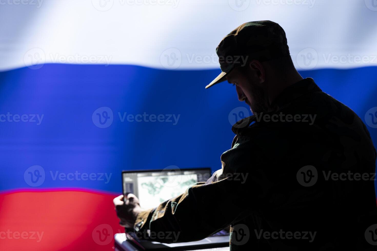 Russian Federal Security Service using radar system to detect ballistic missiles attacking borders. Kremlin regime army using notebook to scan approaching rockets, deploying shields photo