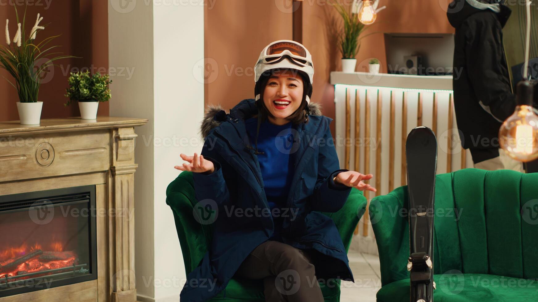 POV of woman in winter attire wearing helmet and goggles, person chatting on videocall conference on ski resort network. Winter sport fan talking to people on internet connection. Tripod shot. photo