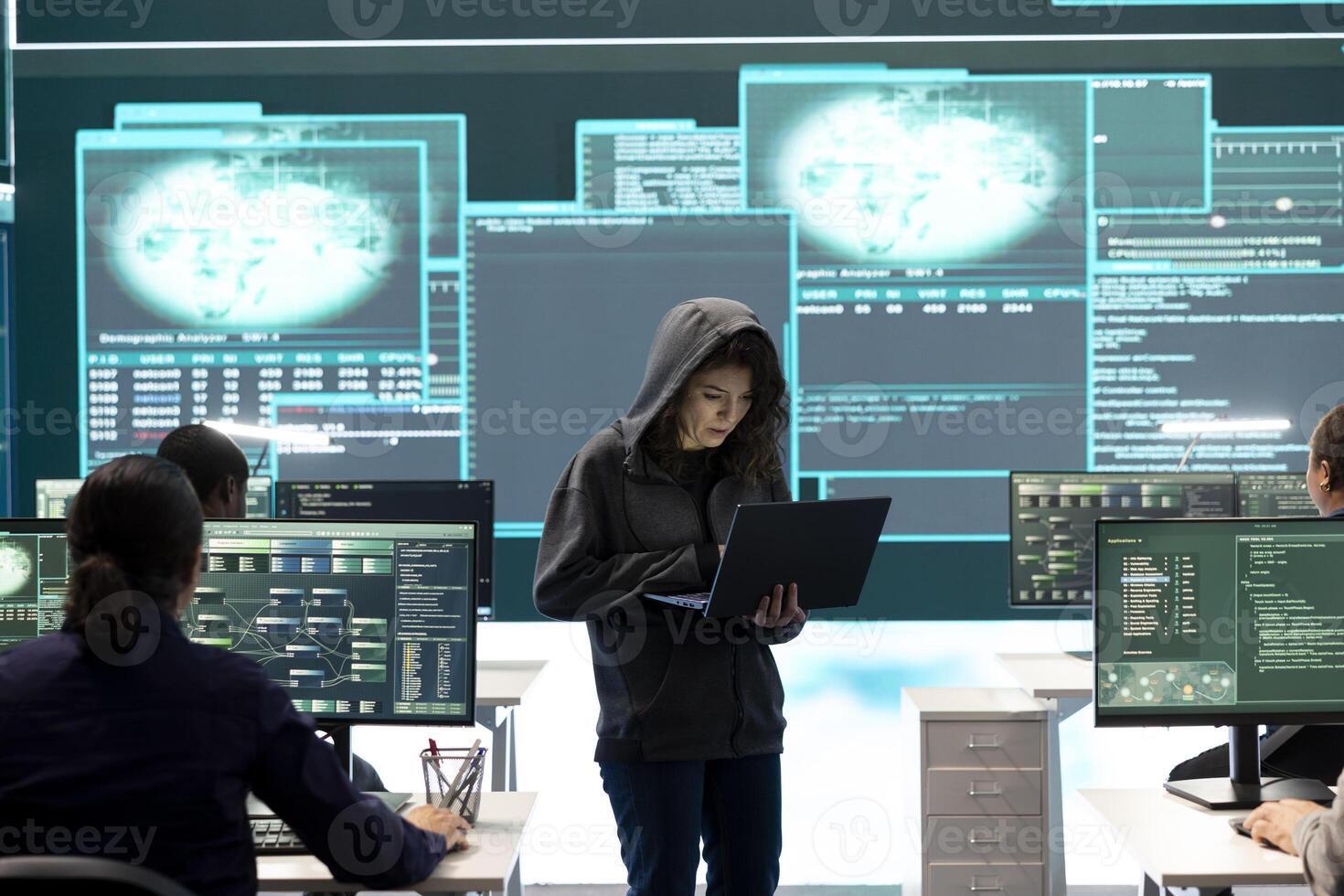 Governmental hacker examines info on a big screen in agency office, using advanced technology to secure computer networks. Working on cyber security and defending against cyberwarfare. photo