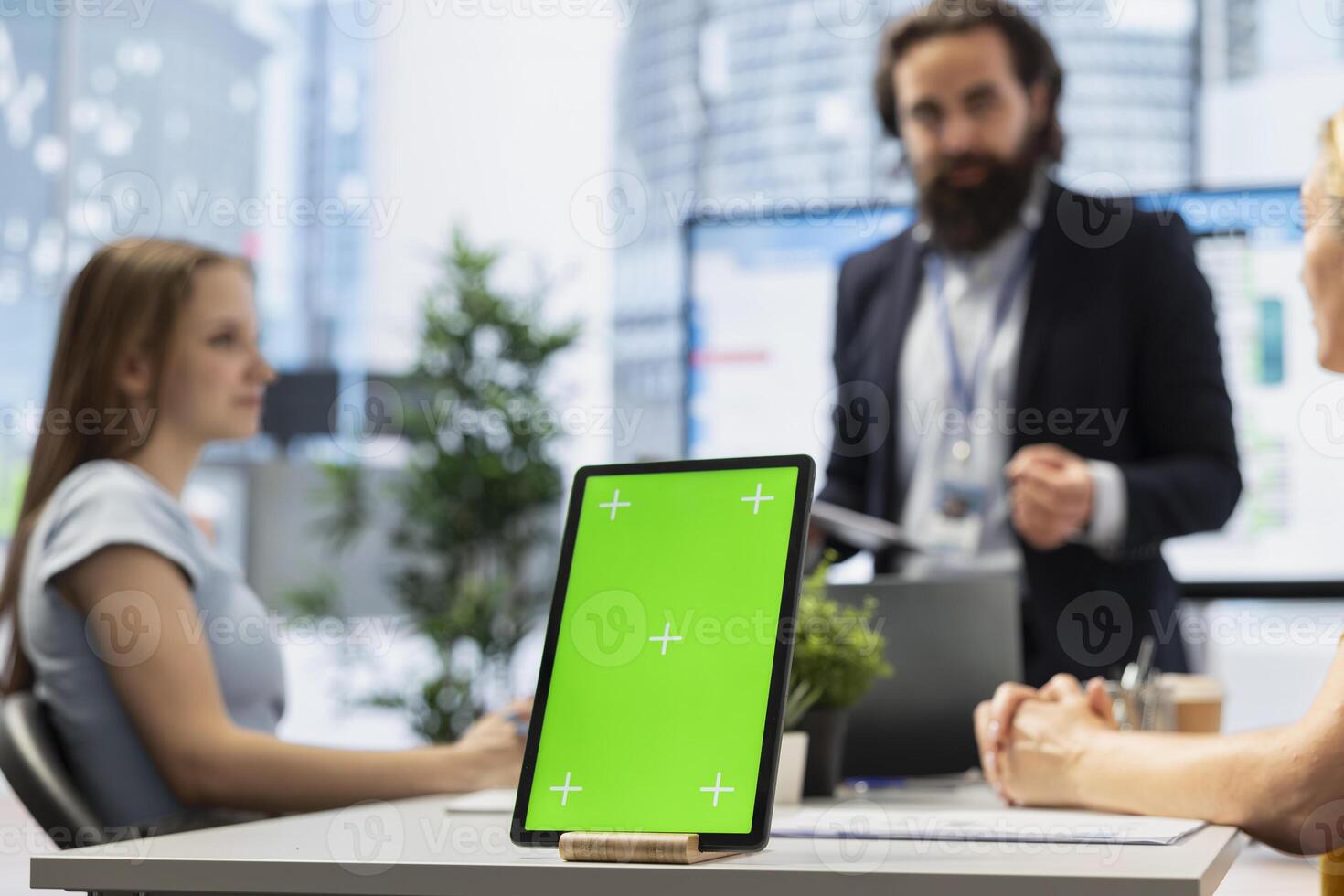 Focus on isolated screen tablet used by counselor in blurry background to show people financial plan. Close up shot of chroma key notebook used by advisor to teach clients how to increase income photo