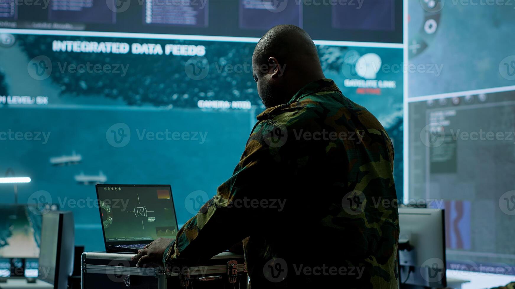Army espionage specialist in a control center collecting satellite cctv data real time surveillance, strategic military operations. Working to ensure national security and protocols. Camera A. photo