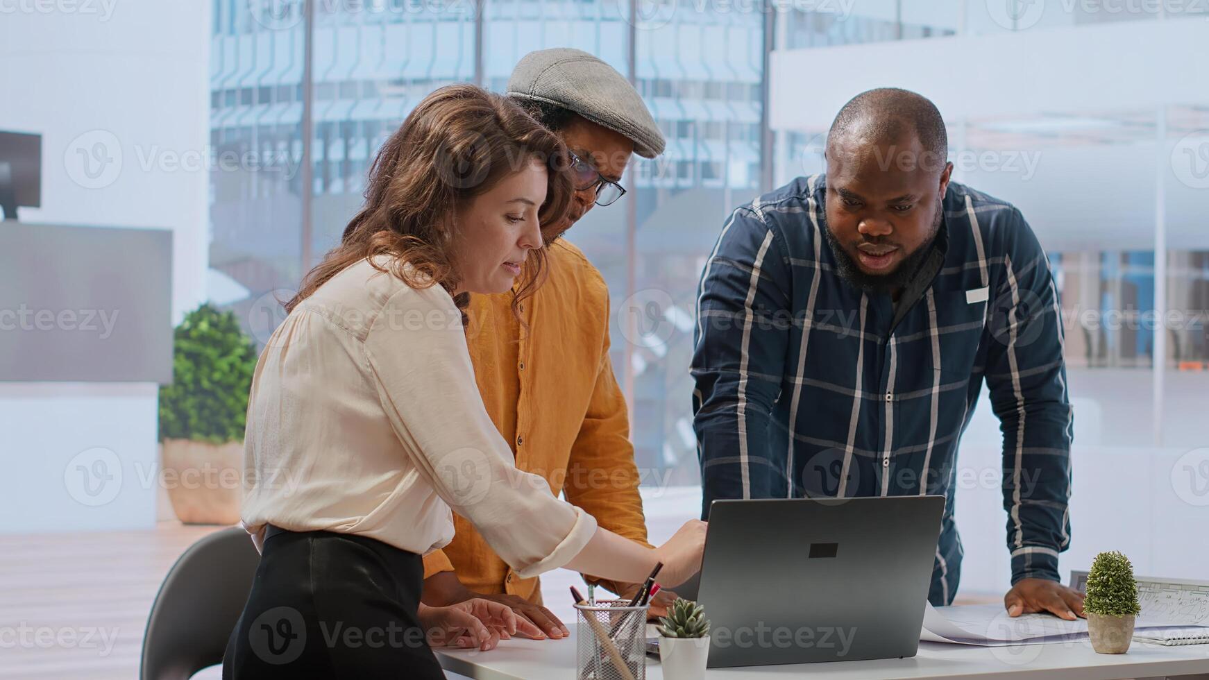 Entrepreneur collaborates with a real estate team of experts to plan a high class office space renting during a tour. Client negotiating the contract and reaching an agreement. Camera B. photo