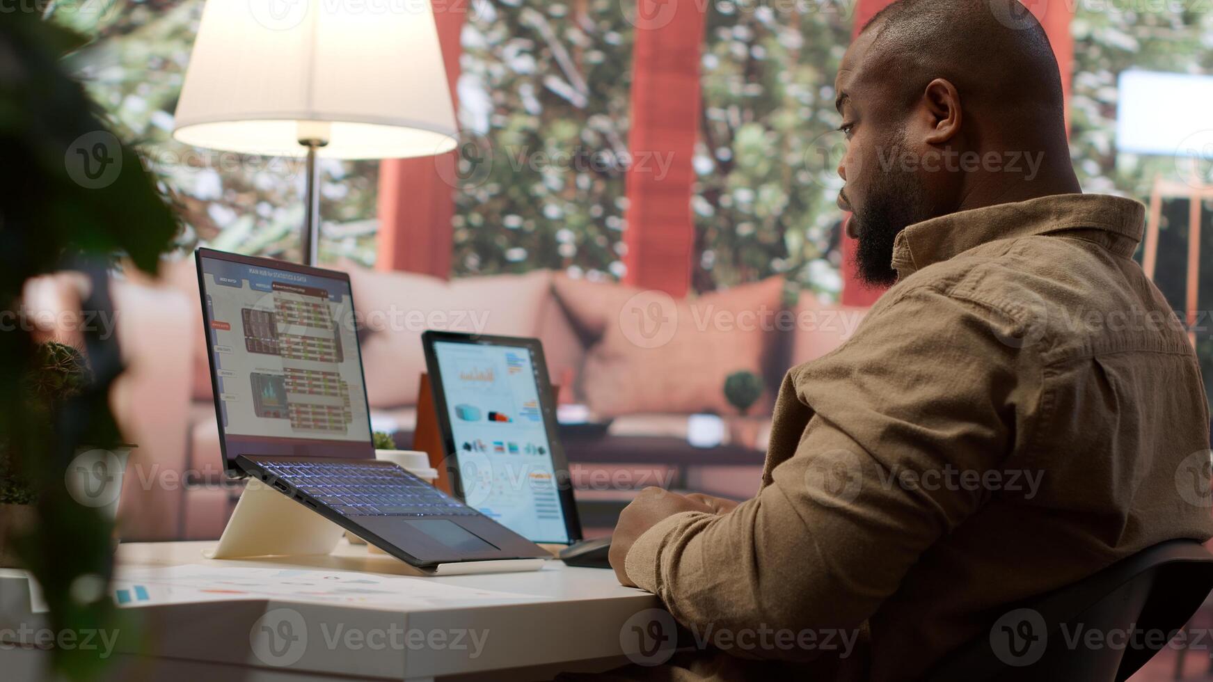 Business analyst calculating project funds and analytics at his home, allocating resources and solving tasks to accomplish objectives. Entrepreneur works on money management accounting. Camera A. photo