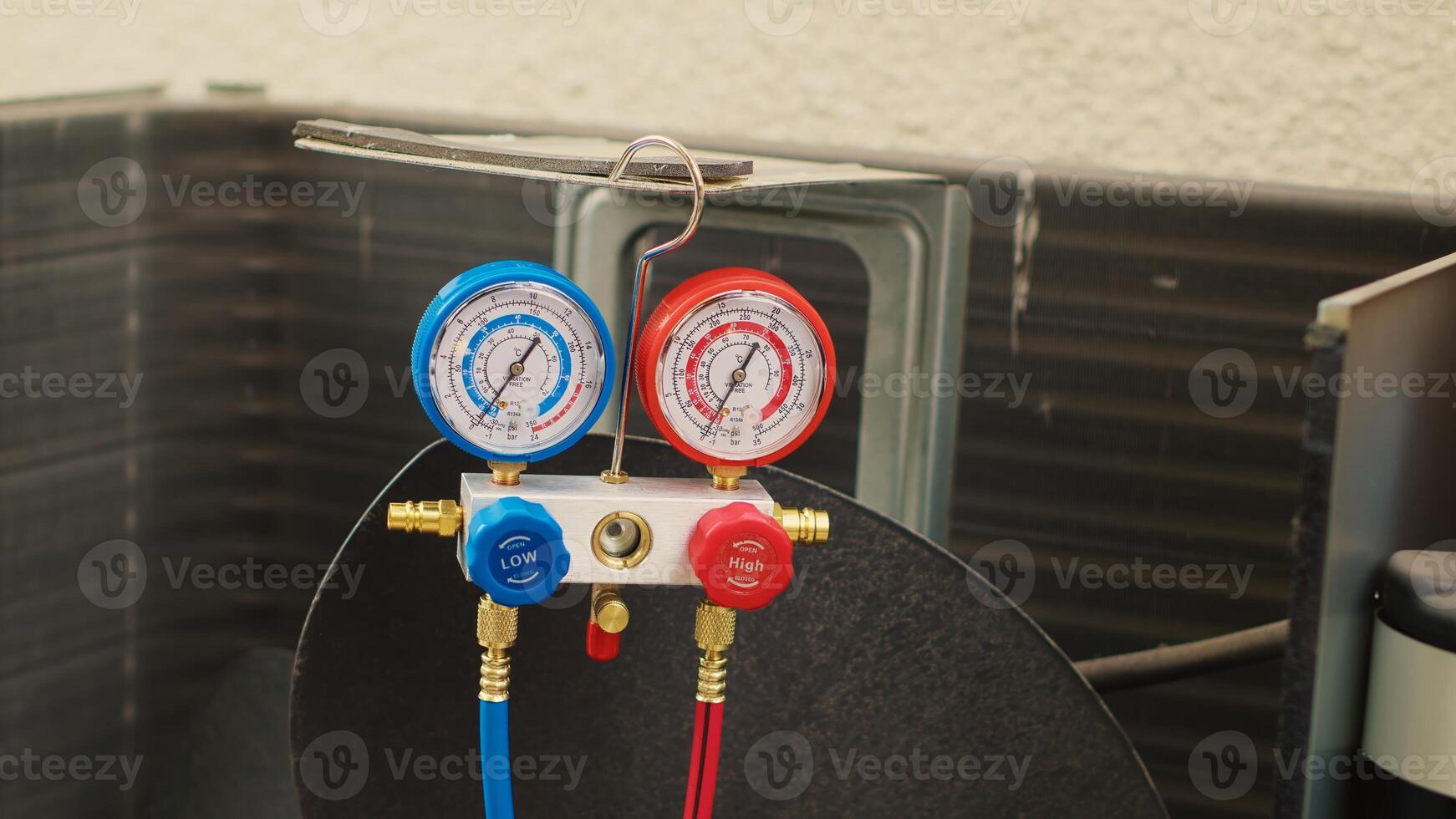 Close up of manifold meters used for checking air conditioner freon in need of service. Set of barometer high or low refrigerant levels benchmarking hvac system internal part photo