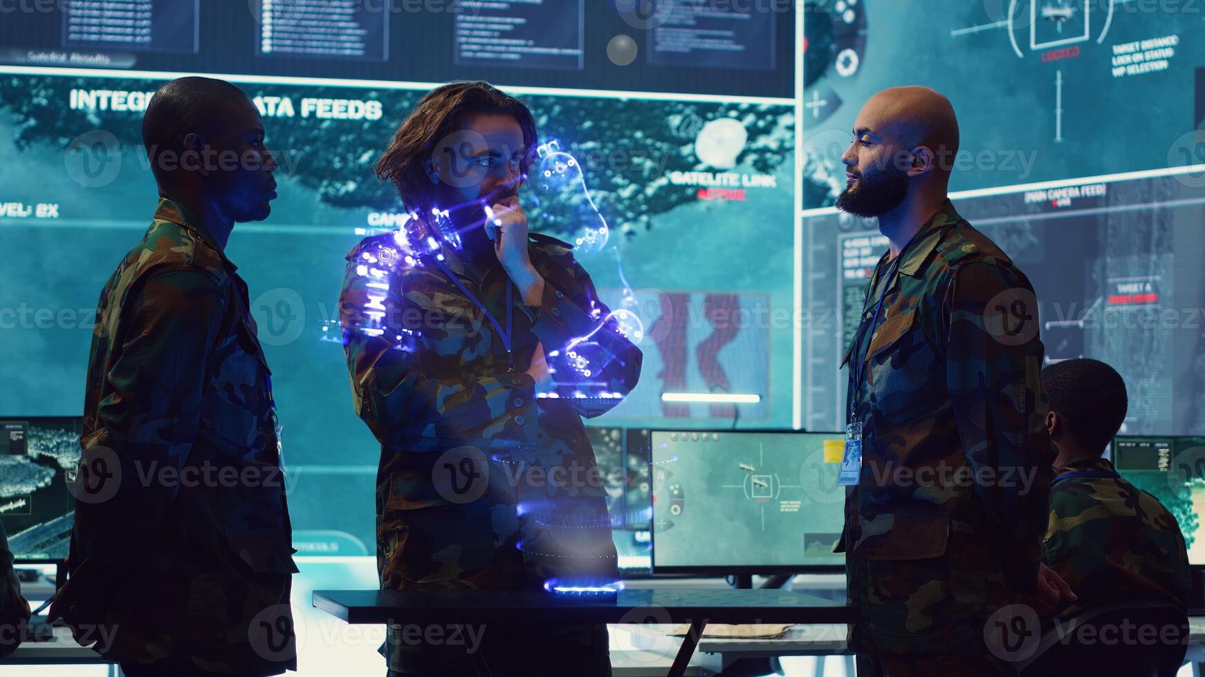 Air force dispatchers looking at AR hologram of surveillance transmission in modern control room. Military soldiers looking at augmented reality simulation of enemy equipment photo