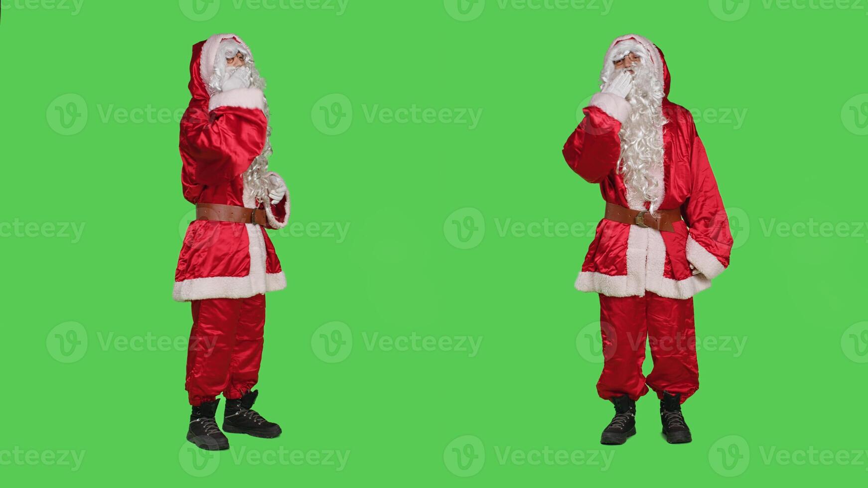 Romantic santa claus sends air kisses over greenscreen backdrop, acting flirty and sweet on camera. Father christmas showing romance gesture, spreading december holiday spirit. photo