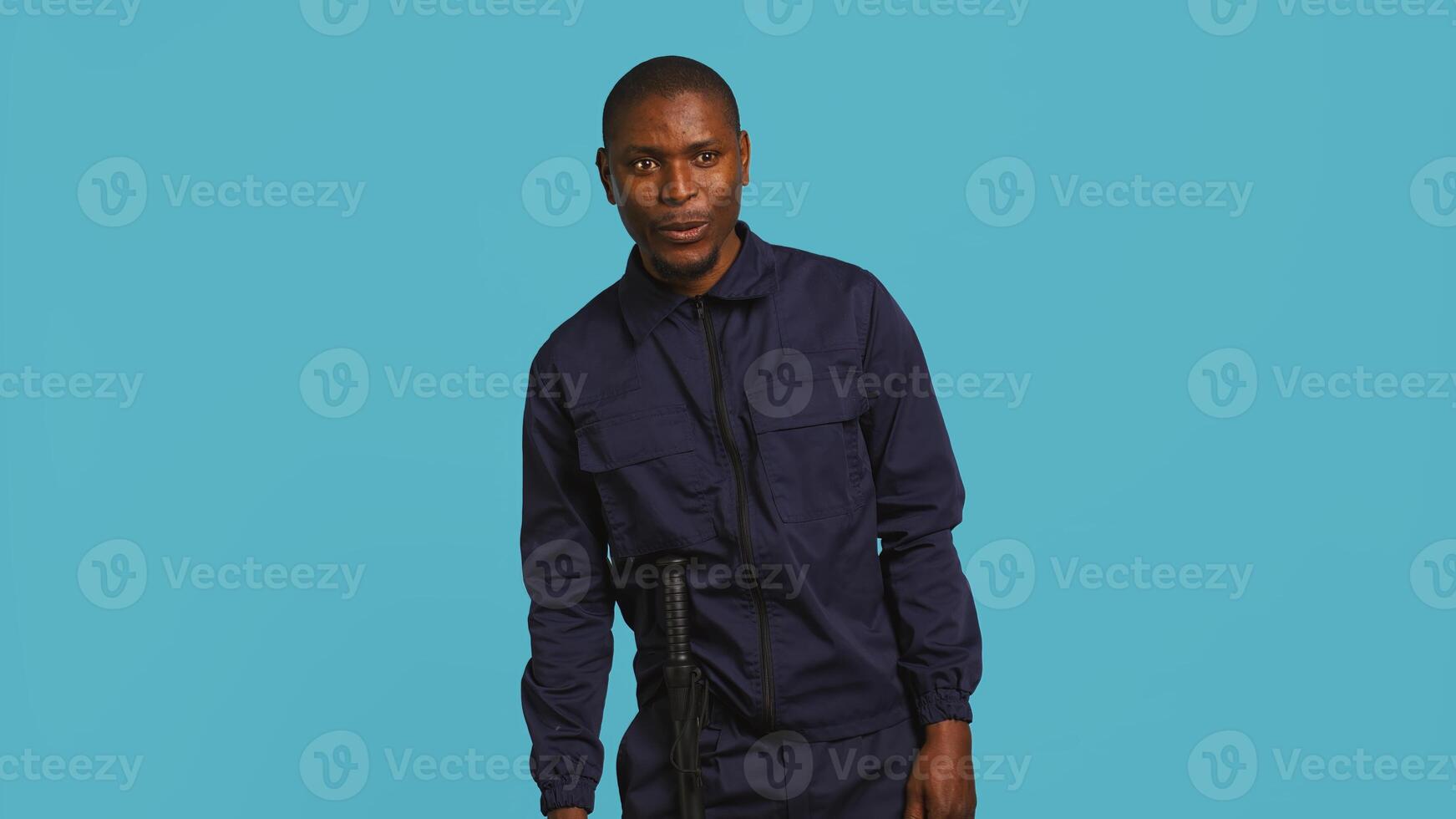 Security guard in uniform feeling amazed while at work, saying wow. Portrait of awestruck bodyguard being astonished during protection job shift, studio background, camera B photo