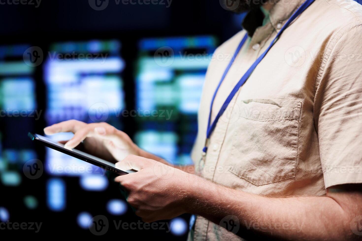 Serviceman using tablet to do maintenance of blade servers responsible with intense data computations demanding high capacity, scalable, error free network to effectively support ai operations photo