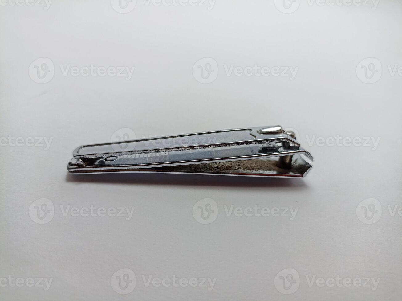 silver nail clippers on a white background, to cut your fingernails and toenails so they are clean photo