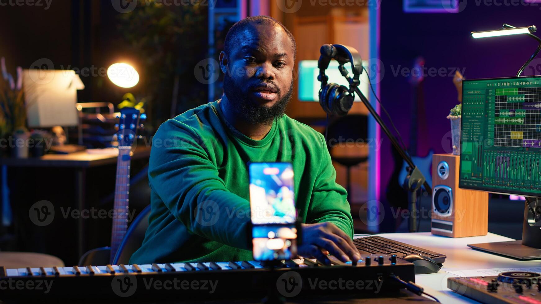 Artist songwriter hosting online master class to teach piano lessons on internet vlog, electronic keyboard notes in home studio. Young composer playing on synthesizer, recording . Camera A. photo