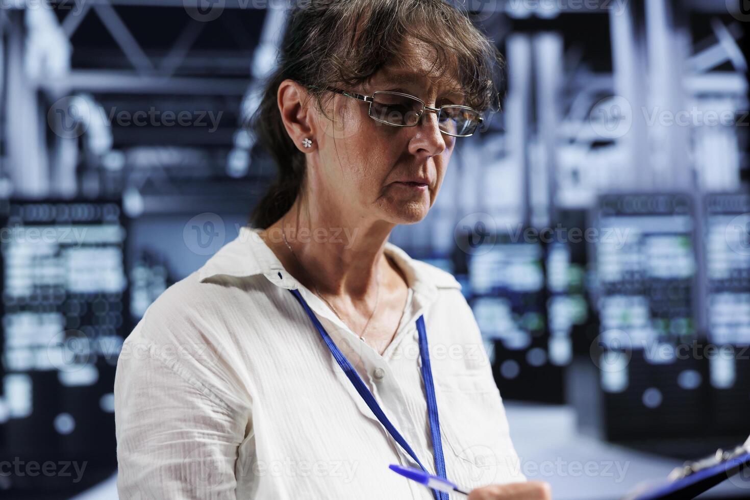 Aged certified IT programmer inside high tech facility providing computing resources needed for AI to process extensive datasets for training. Server clusters storing data used for machine learning photo