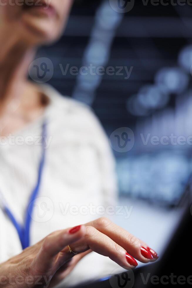 Seasoned employee using laptop, ensuring valuable data remains shielded from potential security instability, safeguarding server room systems against unauthorized access and vulnerabilities, close up photo