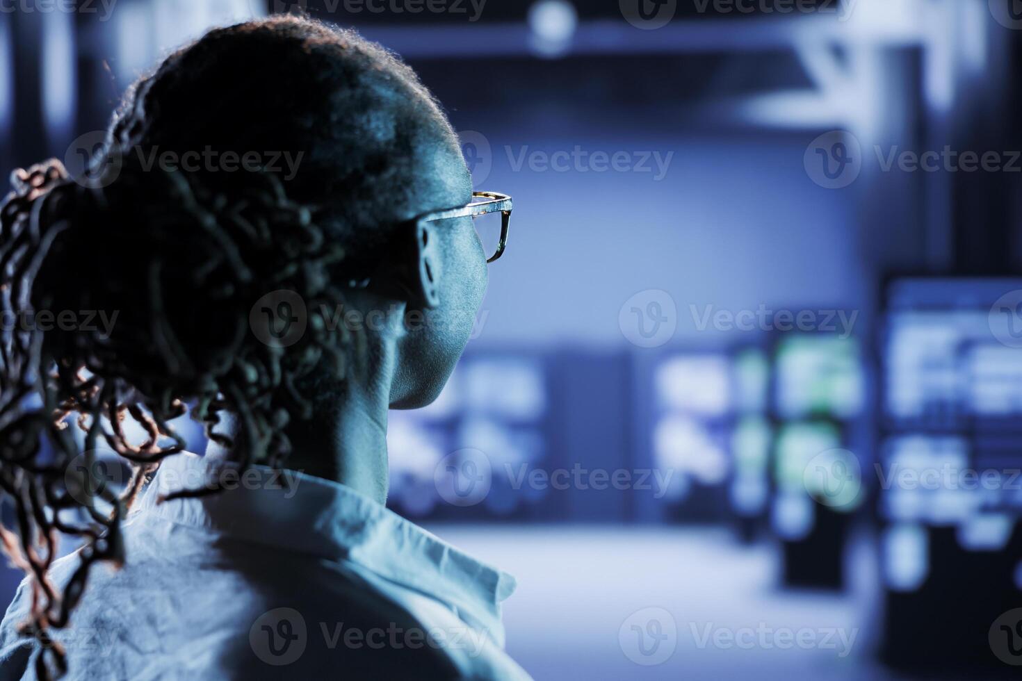 Certified technician in server room future proofing network from downtimes and unexpected system failures. Licensed expert ensuring reliable operations and increased data security photo