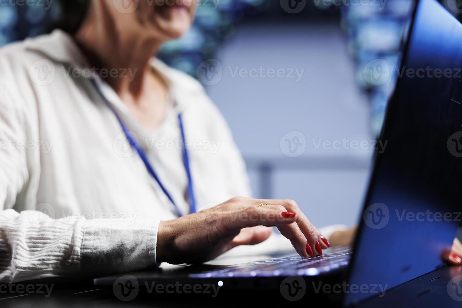 Precise serviceman using laptop, ensuring valuable data remains shielded from security menaces, safeguarding high tech facility servers against unauthorized access and vulnerabilities, close up photo