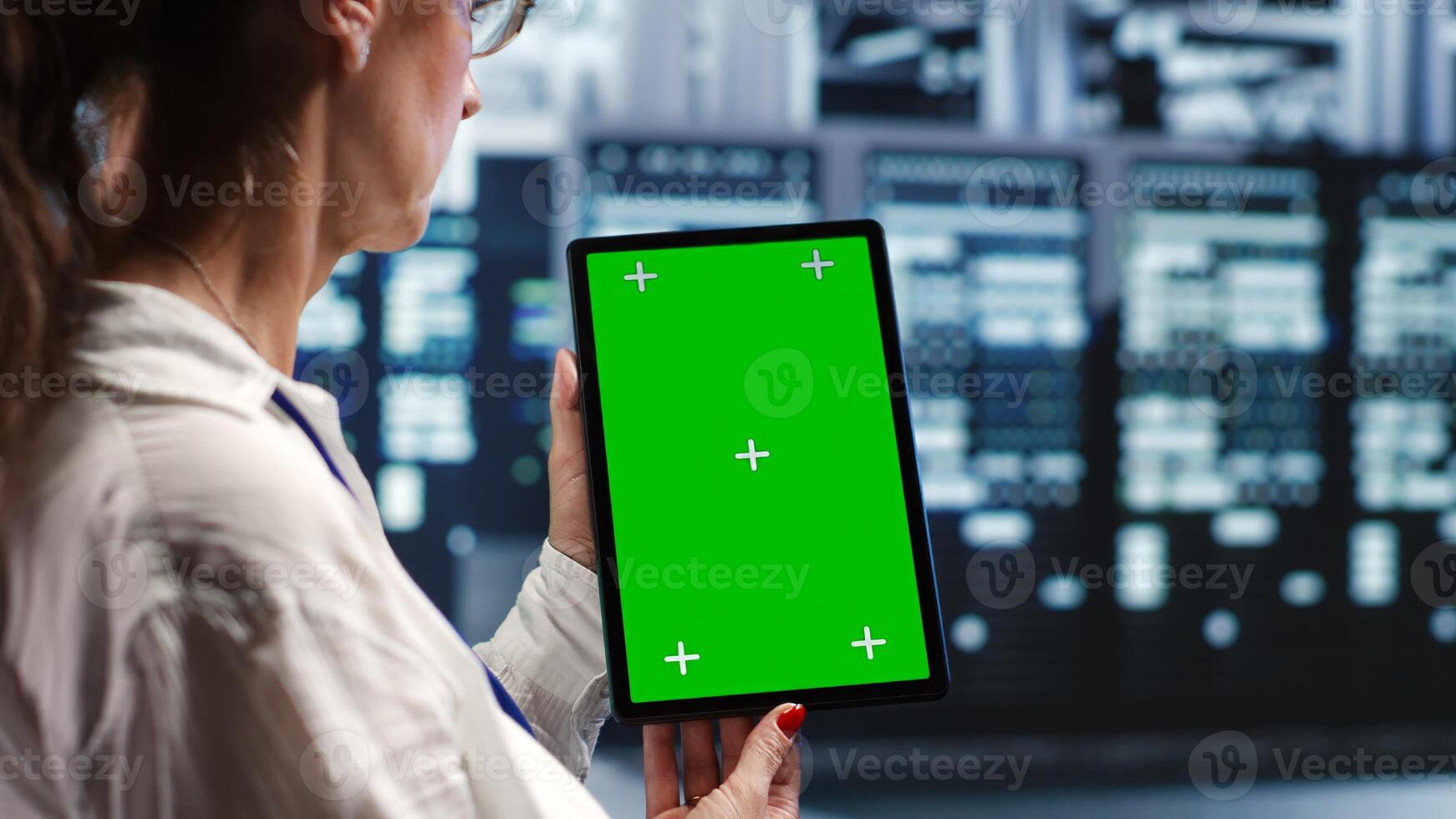 Octogenarian specialist in servers workspace housing high end processors capable of quickly and efficiently performing complex computations and data analysis, using mockup tablet to recondition rigs photo