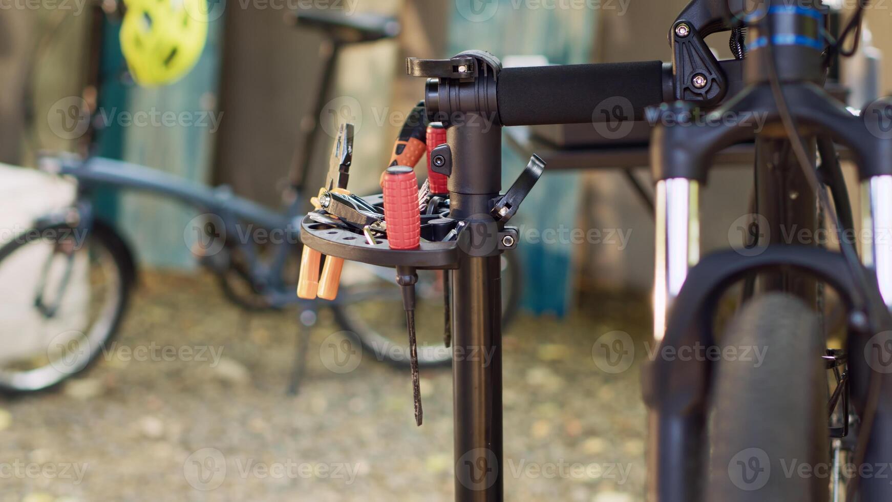Outdoor bicycle repair and maintenance with professional tools placed on repair-stand. The lens capturing various specialized tools prepared for bike fixing and servicing in home yard. photo