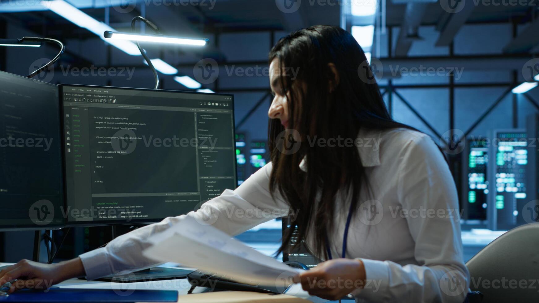 Engineer in data center installing software on computer, helping maintain network, troubleshooting arising issues. IT expert in server room establishing performance benchmarks, camera A photo