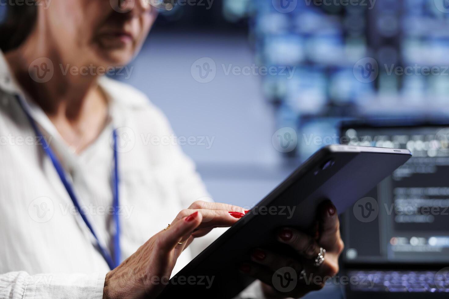 Close up shot of senescent admin writing script code in data center on laptop terminal. Efficient worker doing maintenance work in server room, updating clusters software to prevent malfunctions photo